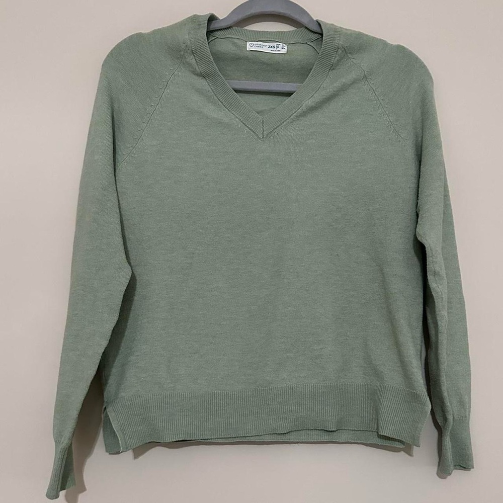 Green V-neck sweater